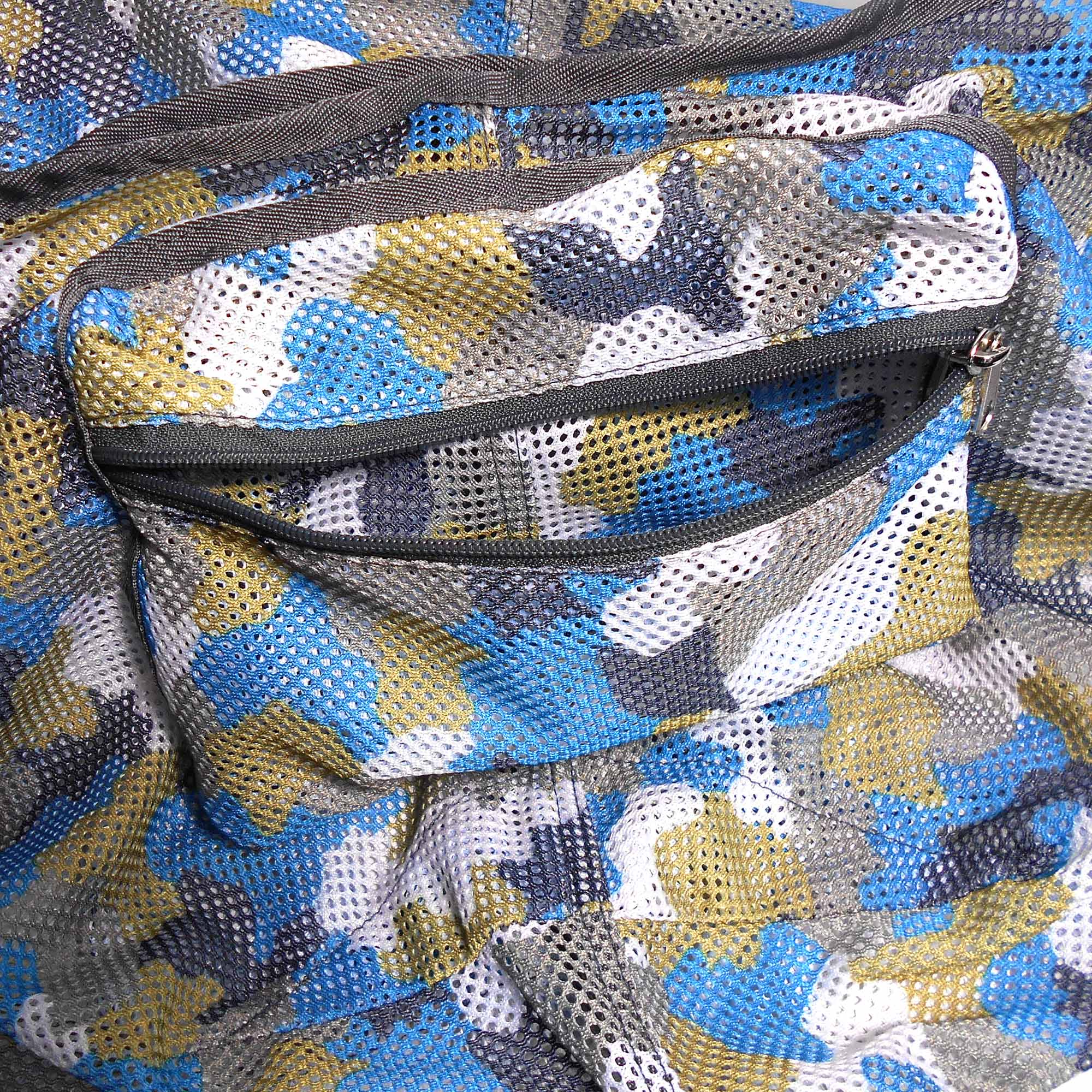 Close-up of a mesh bag with blue, yellow, and gray pattern