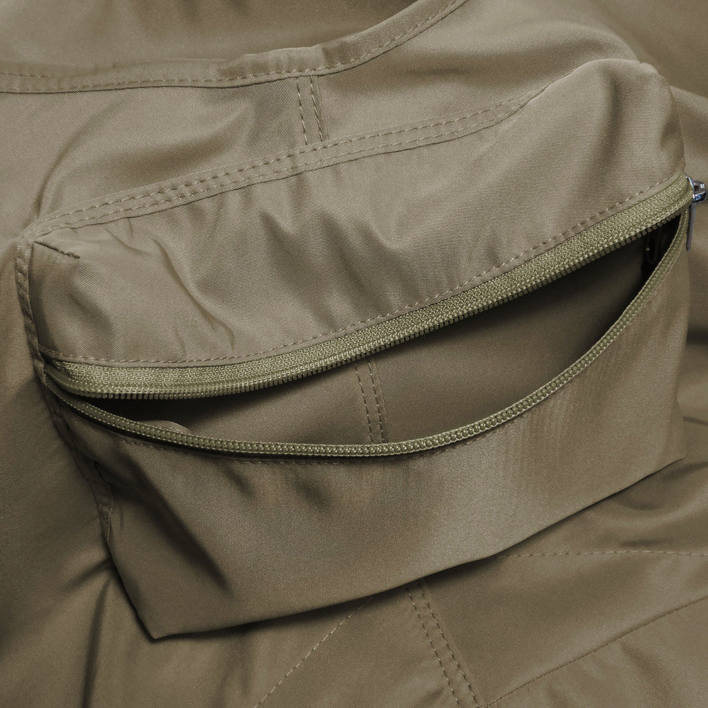 Close-up of a beige pet carrier  with a zipper