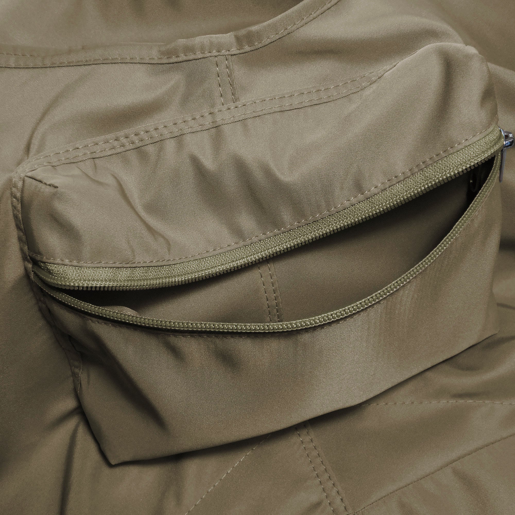 Close-up of a beige pet carrier  with a zipper