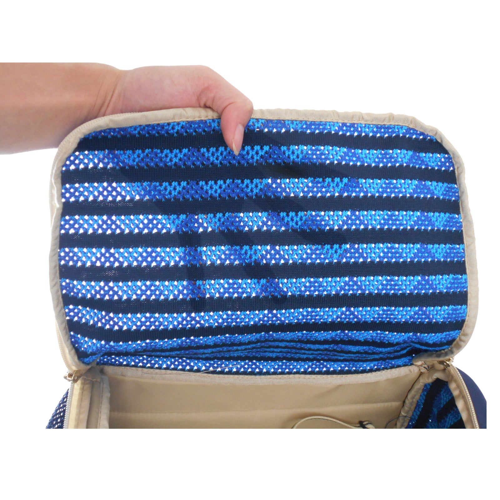 Hand holding a blue striped pouch against a white background